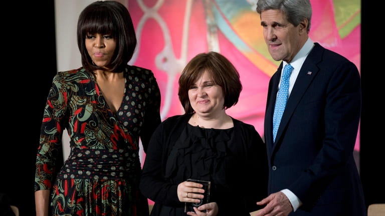 Then First lady Michelle Obama, left, and then Secretary of...