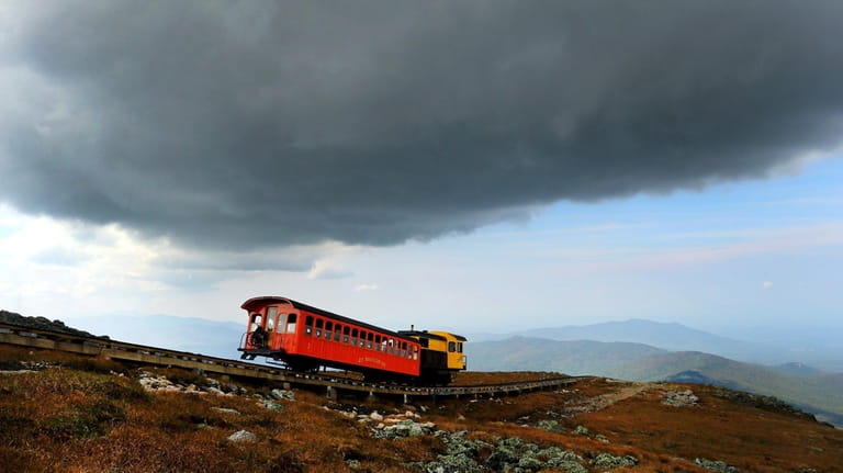 A Cog Railway train passes by on the tracks on...