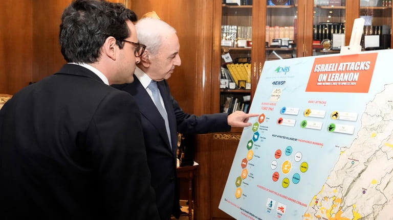 Lebanese Parliament Speaker Nabih Berri, right, shows a map that...