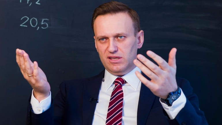 Russian opposition politician Alexei Navalny gestures while speaking during his...