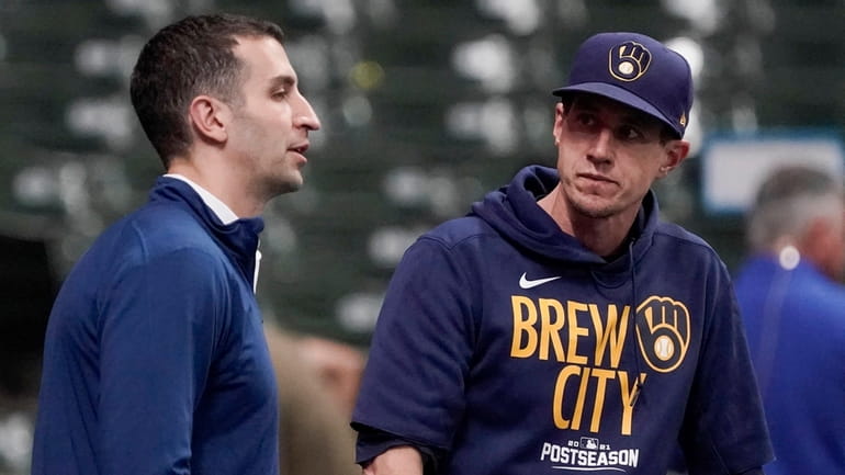 Brewers manager Craig Counsell talks to general manager David Stearns...