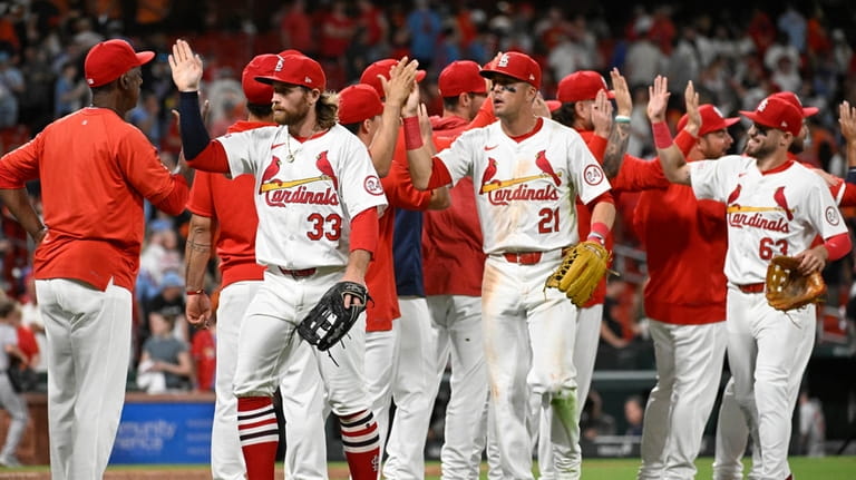 The St. Louis Cardinals celebrate after their victory over the...
