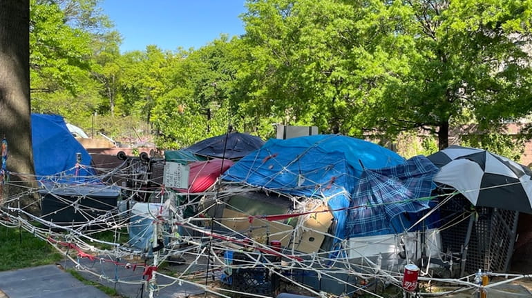 More than a dozen tents make up the encampment along...