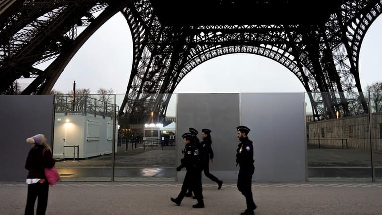 French policemen patrol near the Eiffel Tower, in Paris, Thursday,...