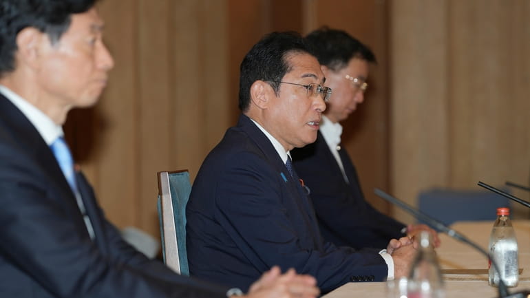 Japanese Prime Minister Fumio Kishida, center, speaks during a meeting...