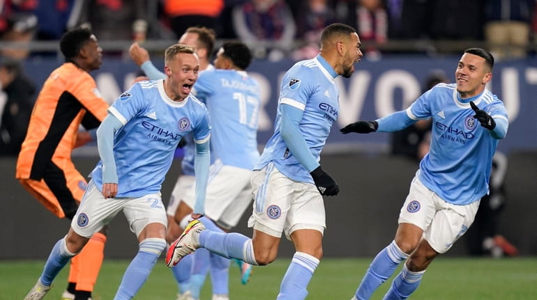 New York City FC players celebrate after defeating the New...