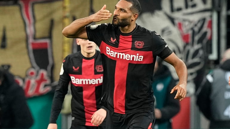 Leverkusen's Jonathan Tah celebrates after scoring his side's third goal...