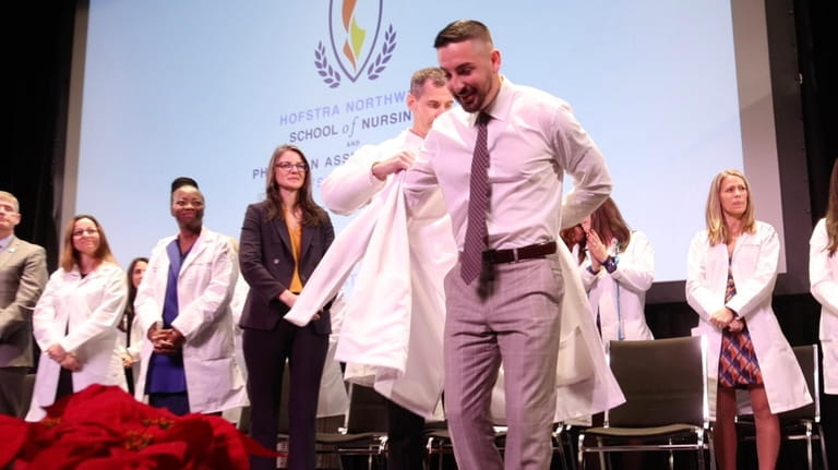Thomas Martin receives his traditional white coat during the winter...
