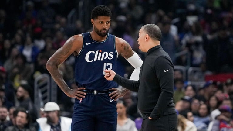 Los Angeles Clippers forward Paul George, left, speaks with coach...