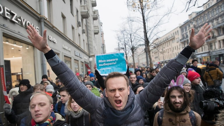 Russian opposition leader Alexei Navalny, center, attends a rally in...