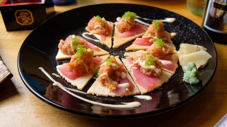 Yuki's pizza is made with thin shrimp crackers topped with...