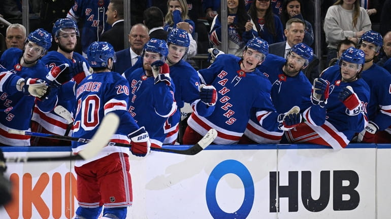 Rangers left wing Chris Kreider is congratulated by teammates after...