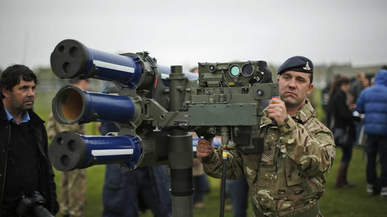 Sergeant Craig from Britain's Royal Artillery regiment holds a high-velocity...