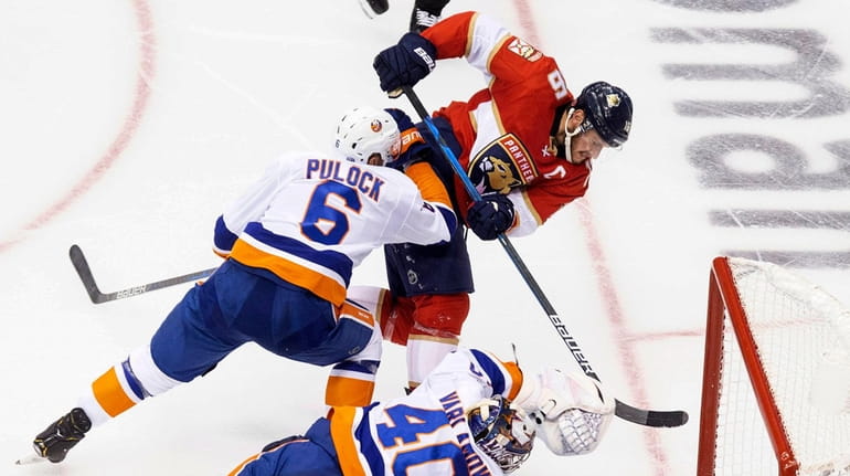 Islanders goaltender Semyon Varlamov dives for the save against Panthers...