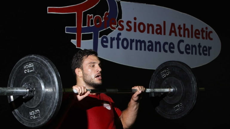 Mixed martial artist Gian Villante lifts weights during a strength...