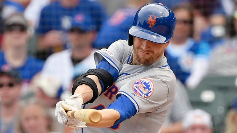 Jacob deGrom of the Mets hits a RBI single in...
