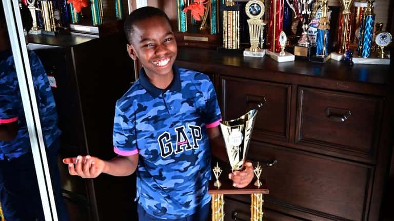 Tani Adewumi's newest chess trophy is nearly as tall as...