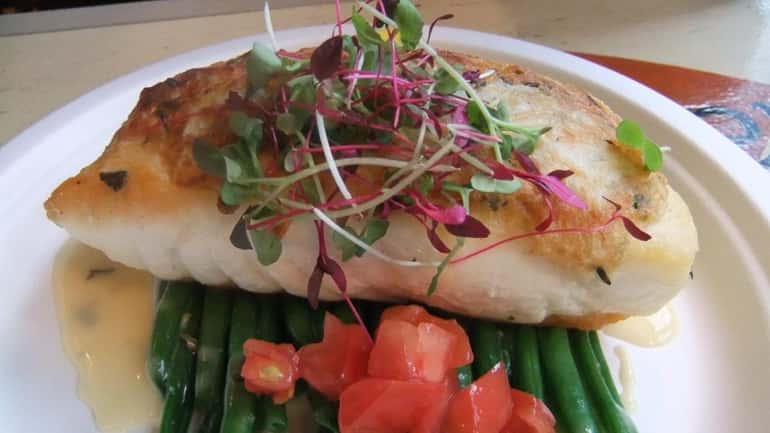 A potato-crusted halibut entree at Bostwick's Chowder House in East...