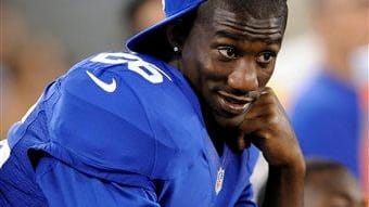 Antrel Rolle looks on from the bench during the second...
