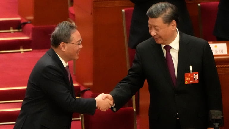 Chinese President Xi Jinping at right is congratulated by Li...