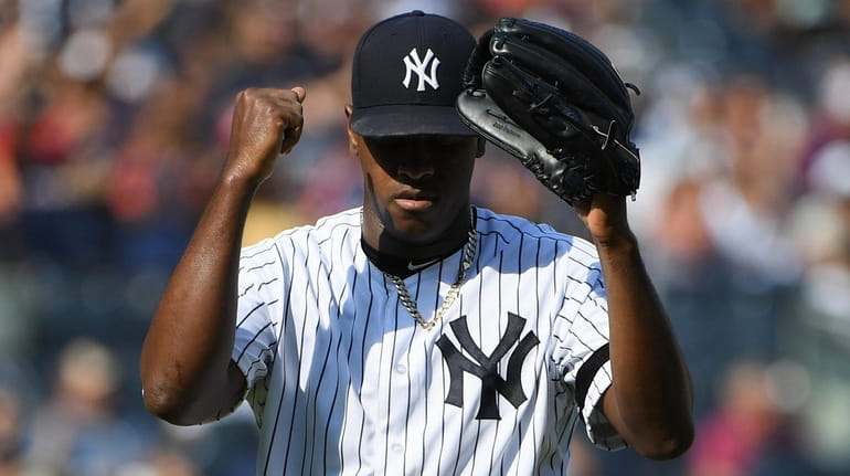 Yankees starting pitcher Luis Severino reacts as he walks to...