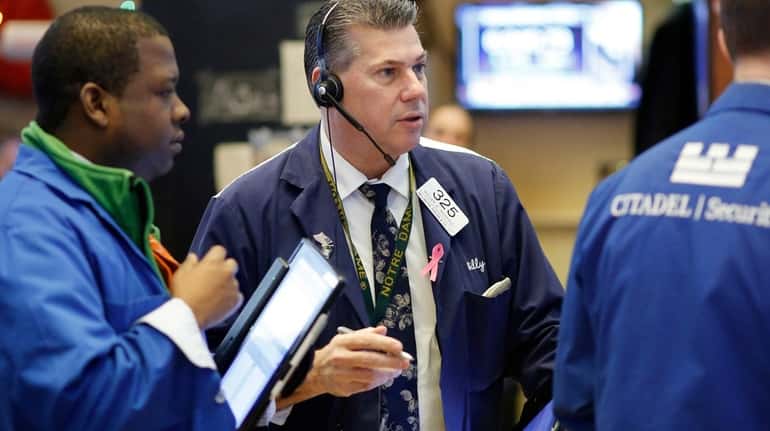 Trader William McInerney, center, works at the New York Stock...