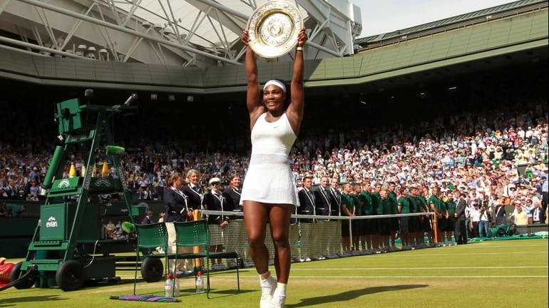FILE - Serena Williams of the United States holds up...