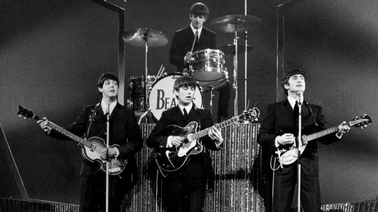 The Beatles on stage at the London Palladium during a...