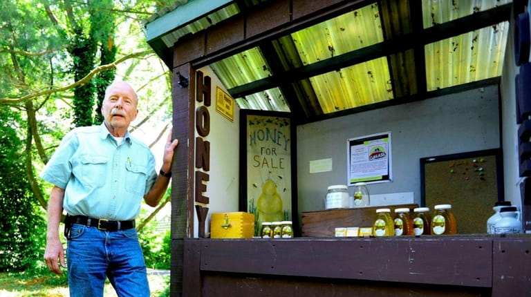 Richard Blohm, a master beekeeper in Huntington, stands for a...