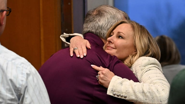 Oakland County prosecutor Karen McDonald hugs Steve St. Juliana, father...