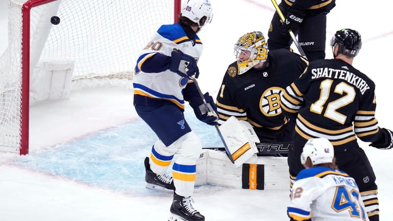 Boston Bruins goaltender Jeremy Swayman (1) looks back at the...