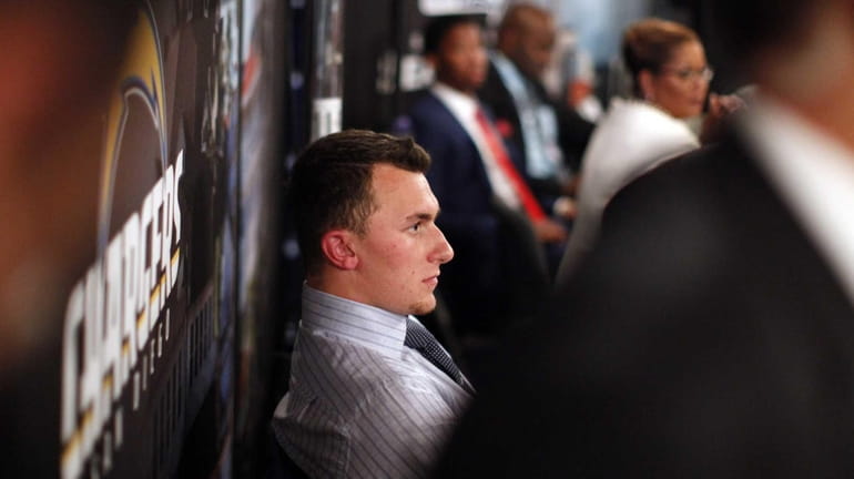 Johnny Manziel, from Texas A&M, waits backstage during the first...