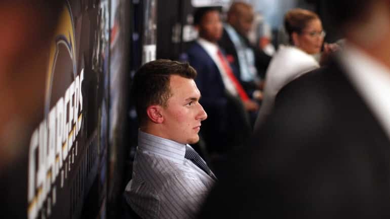 Johnny Manziel, from Texas A&M, waits backstage during the first...