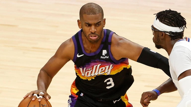 Chris Paul #3 of the Phoenix Suns drives to the...