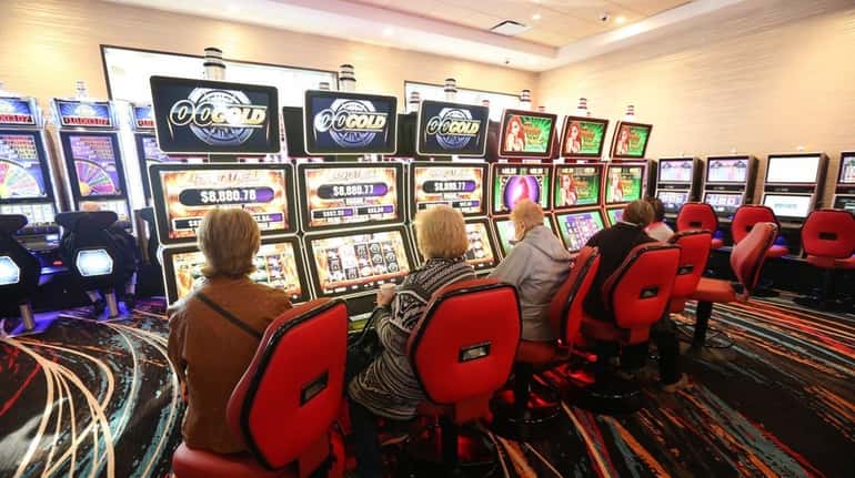 Patrons take to the slot machines at Jake's 58 Hotel...
