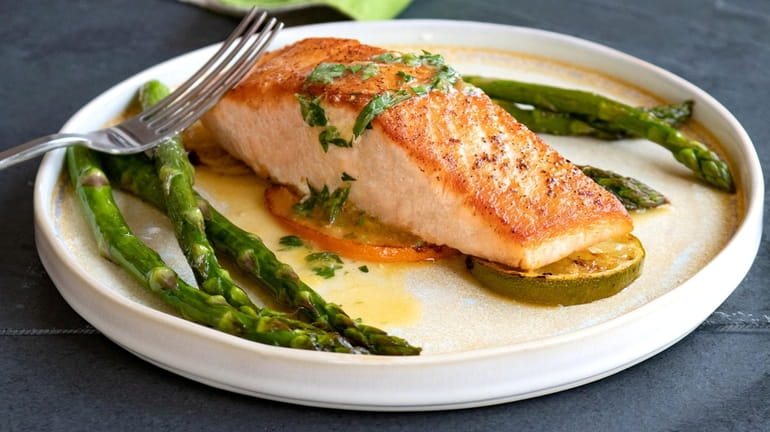 Salmon is seared, then roasted over citrus slices and topped...