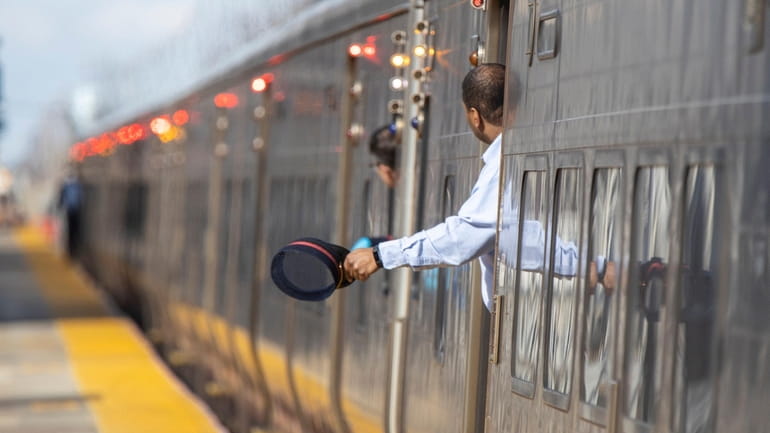 LIRR conductor signals all clear to close doors in Mineola.