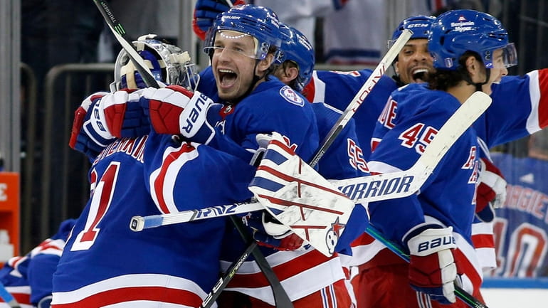 Justin Braun and Igor Shesterkin of the Rangers celebrate after defeating the...