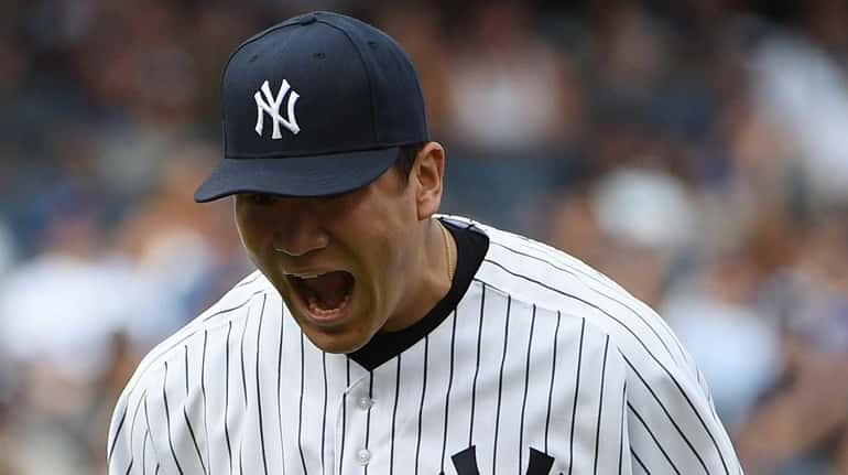 New York Yankees starting pitcher Masahiro Tanaka reacts as he...