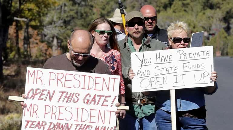 Government shutdown protesters walk to the Grand Canyon National Park...