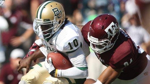 Texas A&M's Damontre Moore sacks Baylor's Robert Griffin III during...