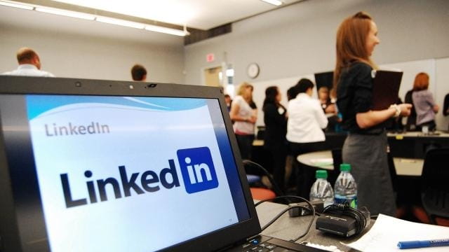 A computer shows a LinkedIn graphic at a social media...