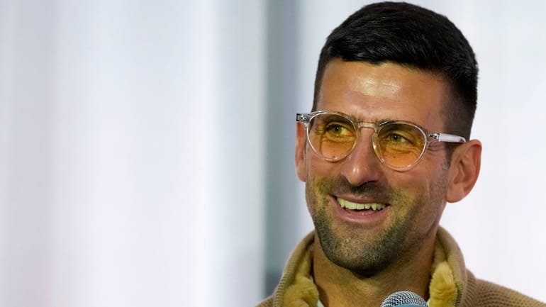 Serbian tennis player Novak Djokovic smiles during a press conference...