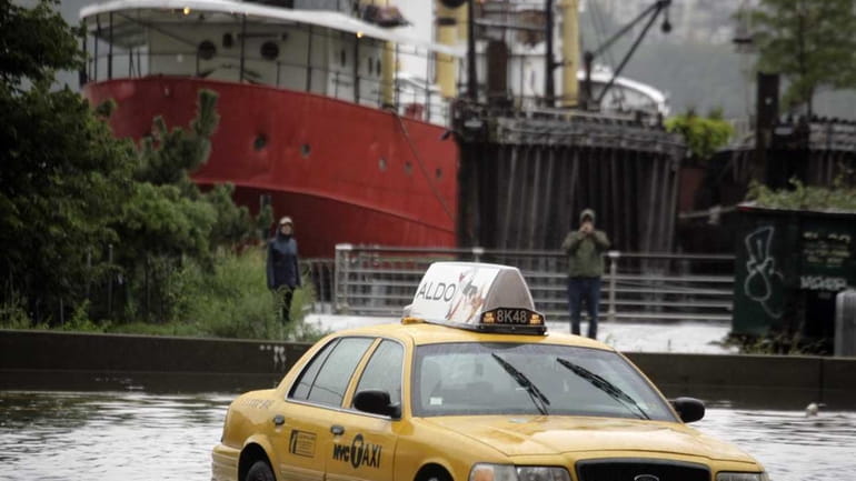 A New York City taxi is stranded in deep water...