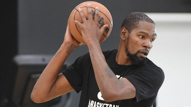 Kevin Durant of the Nets practices during training camp at...