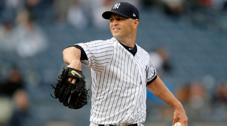 J.A. Happ #34 of the Yankees pitches during the third...