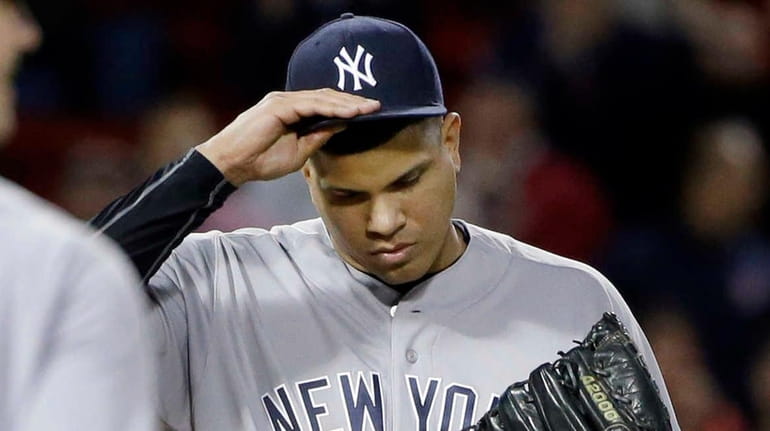 New York Yankees relief pitcher Dellin Betances, right, pauses on...