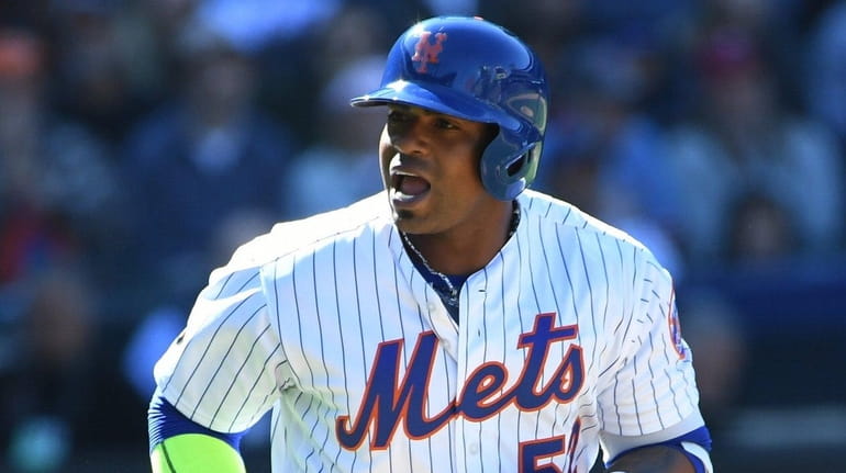 Mets leftfielder Yoenis Cespedes yells to the dugout as he...