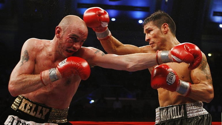 Sergio Martinez of Argentina and Kelly Pavlik throw punches at...