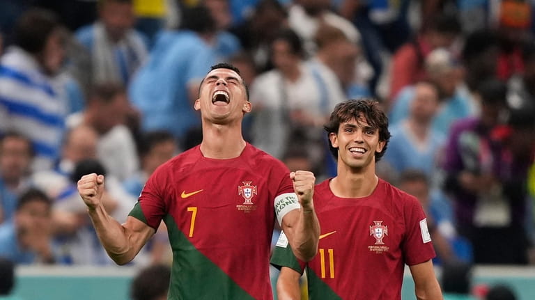 Portugal's Cristiano Ronaldo, left, celebrates , in front of his...